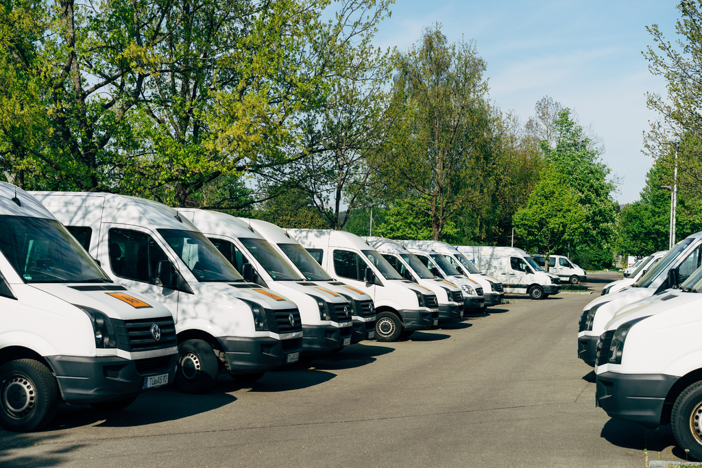 Rows of Sprinter vans in a parking lot