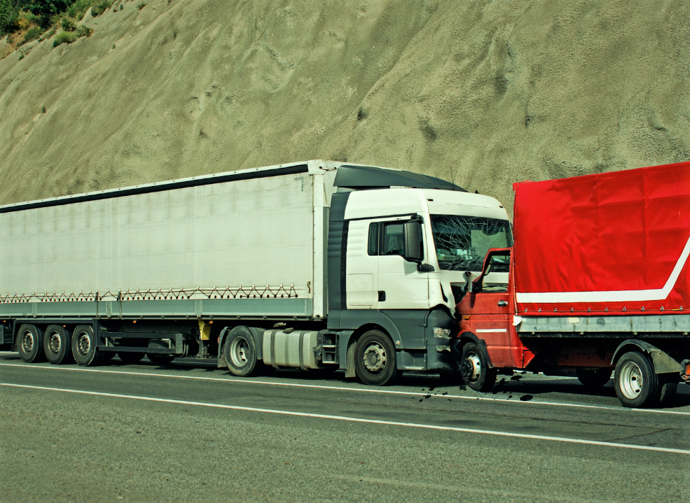 A collision of two trucks in the middle of the road