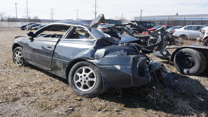 Lindsey’s car after the collision. Nearly the entire rear passenger side has been sheared off.