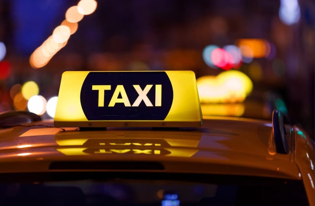 Close up of a taxi sign at night
