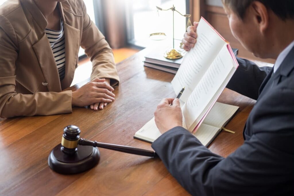 A lawyer shows his client a passage in a book