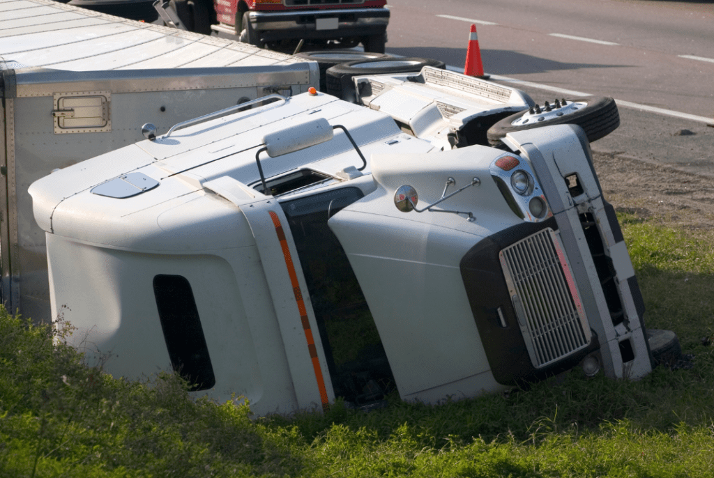 A semi-truck crash on the shoulder of a freeway