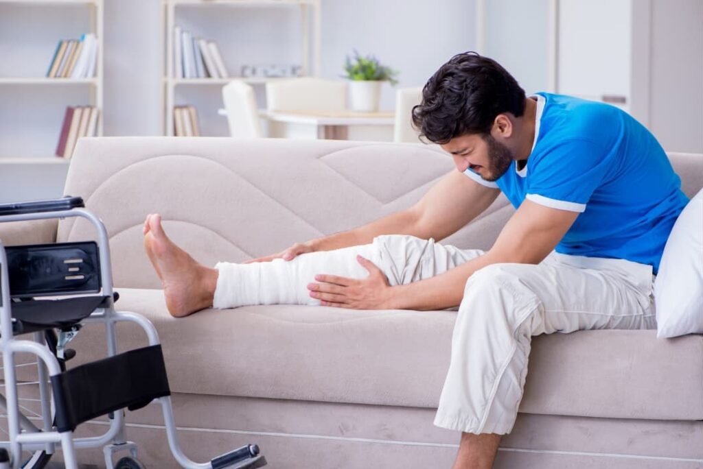 A man with an injured leg recovering at home