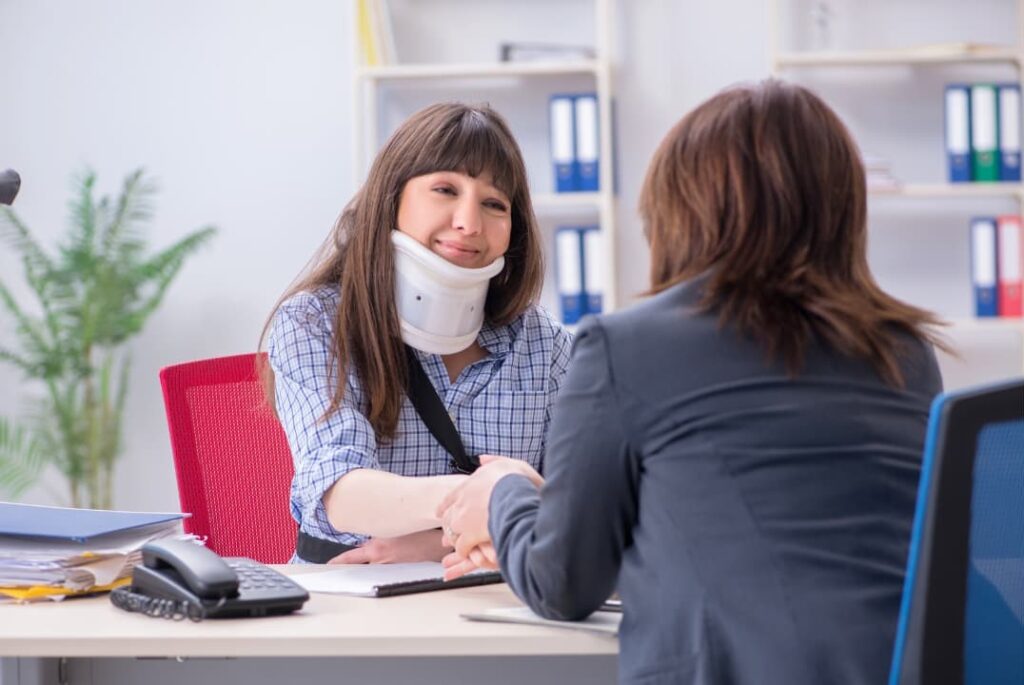 Injured woman visiting a lawyer for legal advice