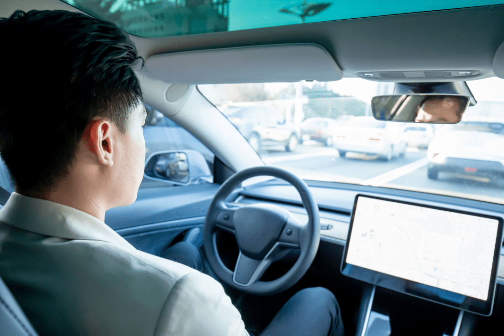 A person riding a self-driving car on the road