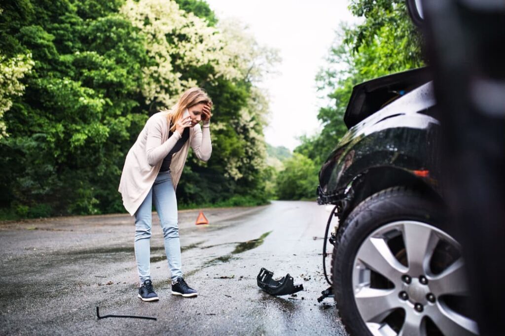 A woman on the phone reporting a car accident