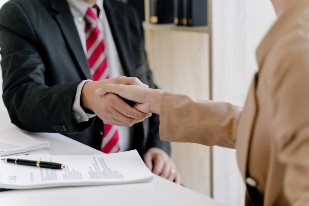 A lawyer consultant shaking hands with a client