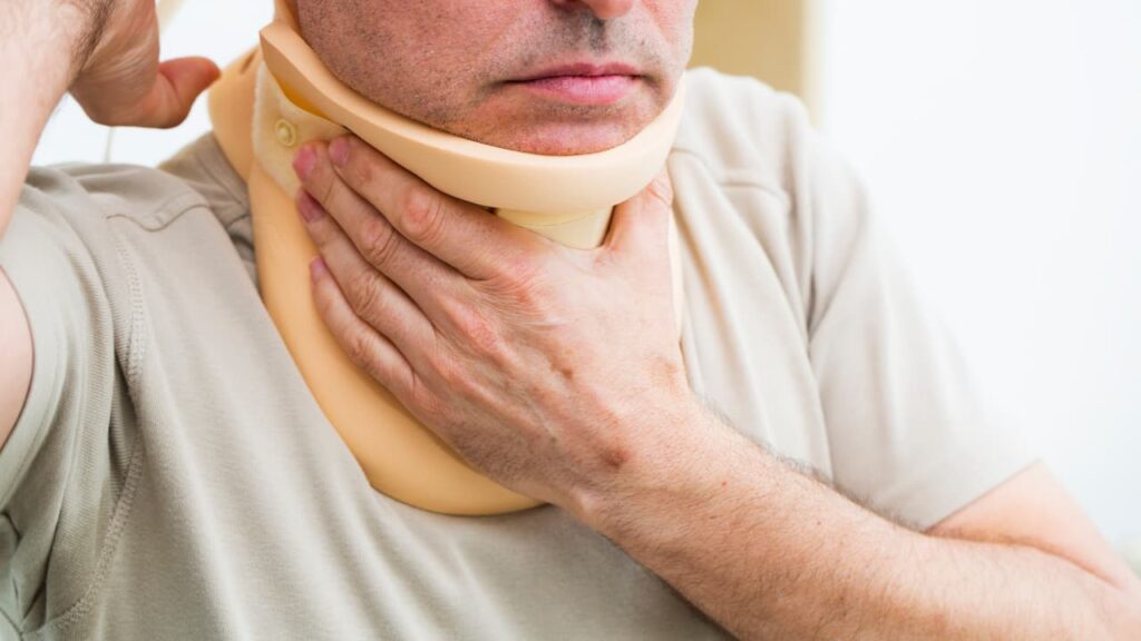 An injured man wearing a neck brace for support 