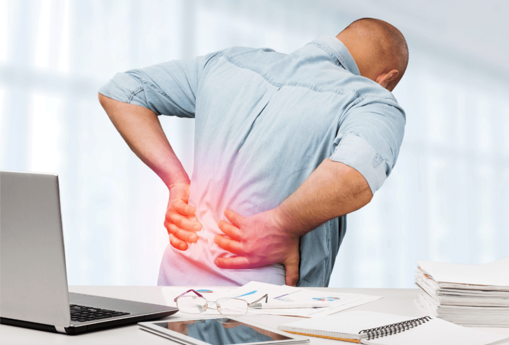 An individual experiencing back pain, showing discomfort and distress as they hold or support their lower back.