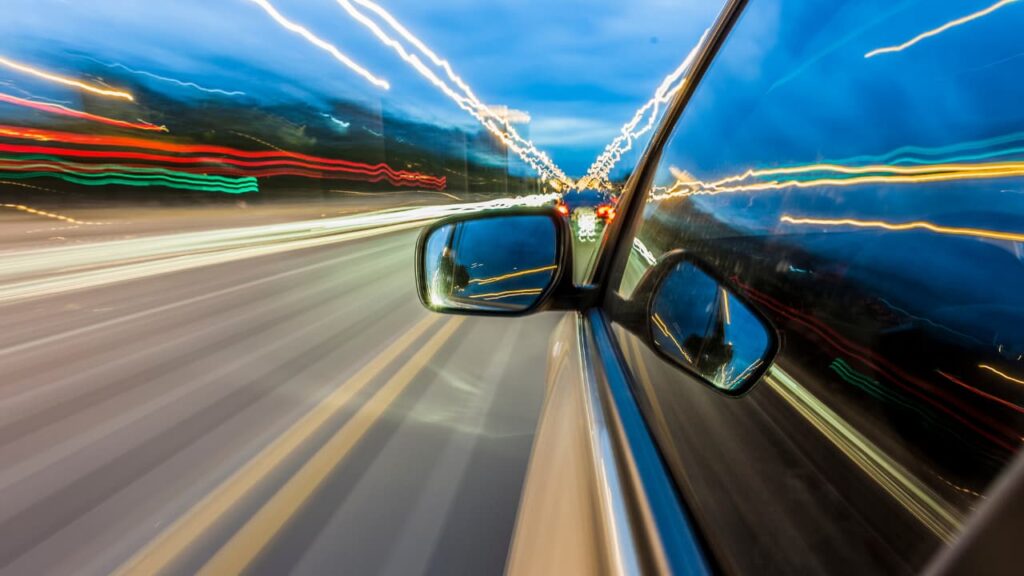 Perspective from the side of a car traveling at high speed.