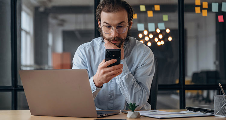 Insurance adjuster reviewing social media on a smartphone to evaluate an Indiana personal injury claim