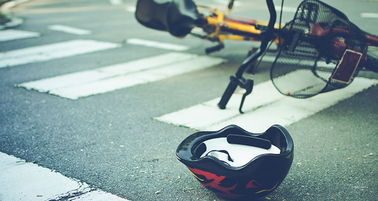 Bicycle helmet and bike on a crosswalk after a crash, representing a South Bend pedestrian accident claim